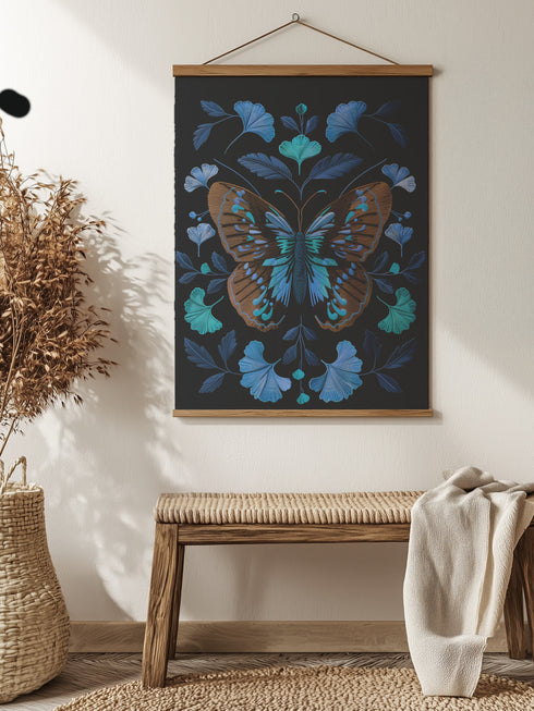 Wall hanging tapestry featuring a large copper butterfly with turquoise and azure blue markings surrounded by blue ginkgo leaves on black background. The textile hangs from wooden dowels with twine, showing detailed 3D embroidery-like texture.